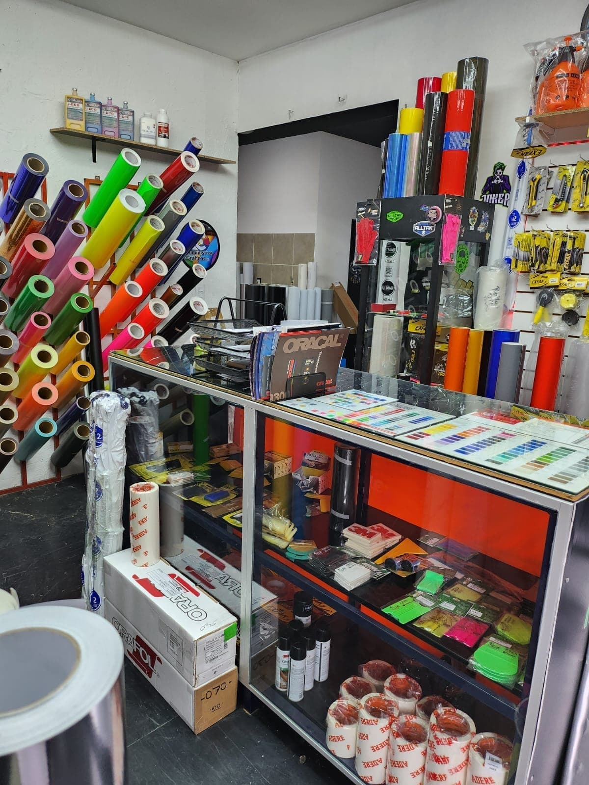 Interior de LC Suministros Gráficos con impresoras, plotters y muestras de vinilos